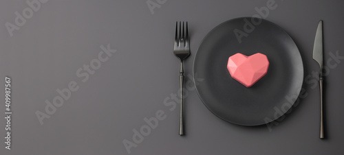 Banner with creatine festive black table setting with pink hearts on a dark background. Valentine's Day, Wedding Day, Birthday, Women's Day and Mother's Day. Flat lay. Copy space.