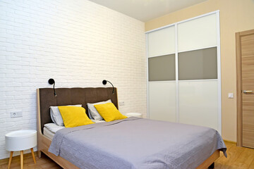 Bedroom with double bed and bedside tables. Ecominimalism