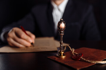 Man signing a Last Will and Testament document in notary public office.