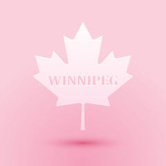 Obraz na płótnie Canvas Paper cut Canadian maple leaf with city name Winnipeg icon isolated on pink background. Paper art style. Vector.
