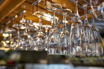 Fototapeta na wymiar glasses for wine above a bar rack