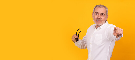 isolated senior adult man smiling pointing