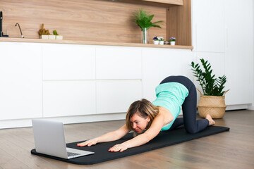 Woman stretching in front of the laptop