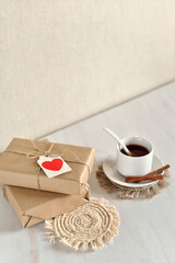 background with gift boxes wrapped in craft paper and decorated with a paper heart.