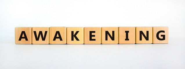 Awakening symbol. Wooden cubes with the word 'awakening'. Beautiful white background, copy space. Business and awakening concept.