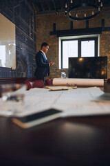 Office worker reading an email on his mobile device