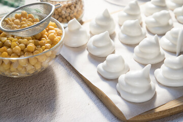 Homemade marshmallows from Aquafaba on a light background. Whipped chickpea broth is a source of vegetable proteins.