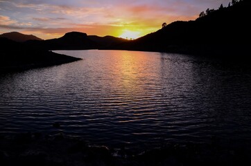 Sun behind a Mountain Silhouette
