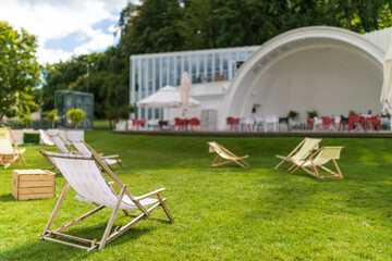 Summertime in Gdynia: Deckchairs on the green grass by the summer scene on Plac Grunwaldzki in...