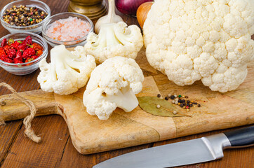 Head of cabbage fresh organic cauliflower on wooden background, spices. Studio Photo