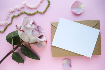 postcard layout. beautiful rose, jewelry and envelope on white background 