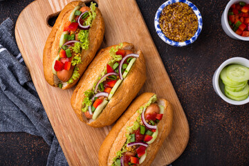 Hot dogs with sausage, sauces and vegetables