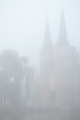 Old city center of Delft in a foggy and wet cold day