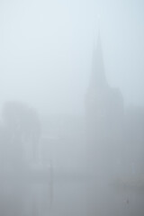 Old city center of Delft in a foggy and wet cold day
