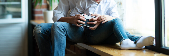 children's hands of a boy and a girl hold an old film camera.