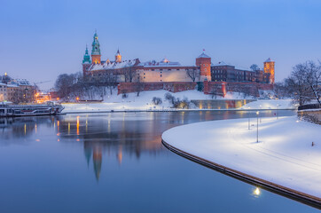 Fototapeta premium Krakow winter, night Wawel Castle over Vistula river, snow, Poland