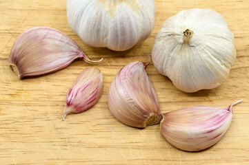 Close up of cloves and bulbs of fresh garlic or 