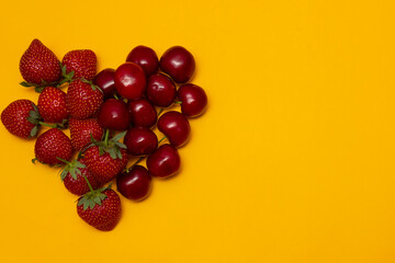 Red heart made of strawberries and cherries