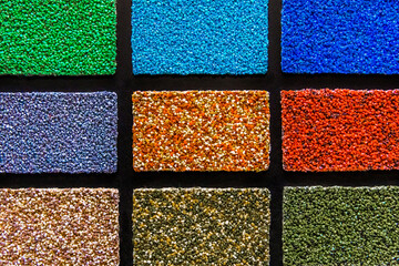 Samples of multi-colored drywall construction material for the decoration of the facade and interior of buildings