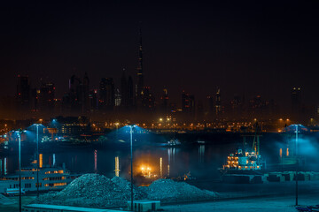 Obraz na płótnie Canvas Dubai city skyline at night as seen from port side