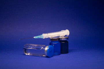 three transparent Vaccine bottle phial with no label, medical syringe injection needle. isolated on...