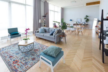 The interior design of the studio apartment in Scandinavian style. A spacious huge room in light colors. stylish expensive luxury furniture.