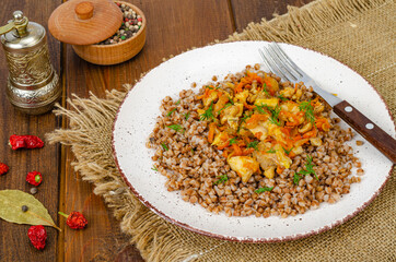 Buckwheat porridge with meat and vegetables. Studio Photo