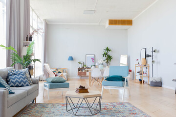 The interior design of the studio apartment in Scandinavian style. A spacious huge room in light colors. stylish expensive luxury furniture.