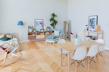 The interior design of the studio apartment in Scandinavian style. A spacious huge room in light colors. stylish expensive luxury furniture.