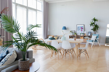 The interior design of the studio apartment in Scandinavian style. A spacious huge room in light colors. stylish expensive luxury furniture.