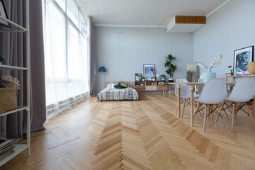 The interior design of the studio apartment in Scandinavian style. A spacious huge room in light colors. stylish expensive luxury furniture.