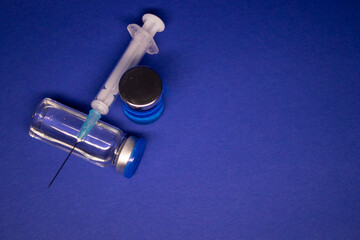 two transparent Vaccine bottle phial with no label, medical syringe injection needle. isolated on...