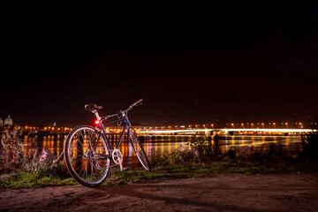 The blue bicycle stands on the banks of the neva river