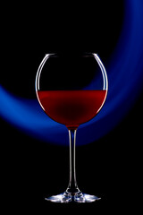 Rounded cocktail glass with a red alcoholic drink on a black background with a light pattern. Light blue drawing.