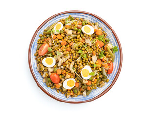 Mung bean porridge with quail eggs, tomatoes and microgreen sprouts isolated on a white background. Top view.