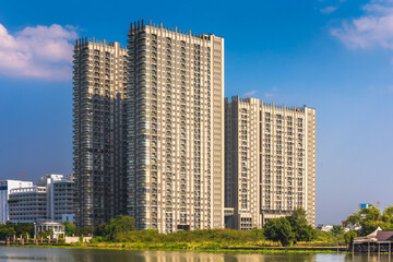 Fototapeta na wymiar Modern Apartment Buildings on a Sunny Day with a Blue Sky on Chao Phraya River Embankment in Bangkok, Thailand