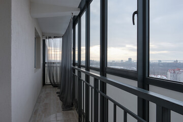 Long typical Panoramic balcony with lattice in modern Russian multistory residential house
