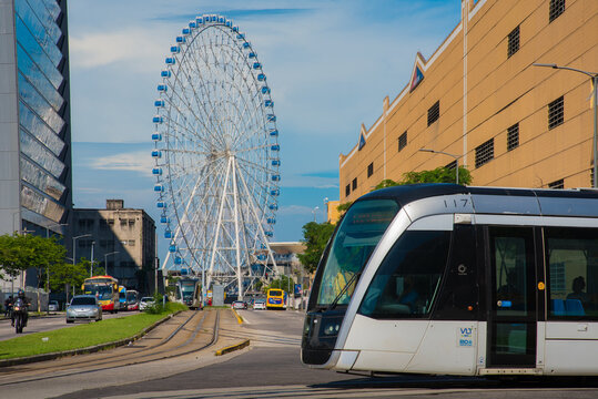 Rio de Janeiro, Brazil - January 7, 2021: VLT tram is passing in front of the Rio Star ferris wheel in the city center.