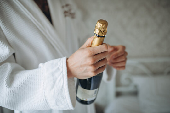 man open champagne bottle on white background