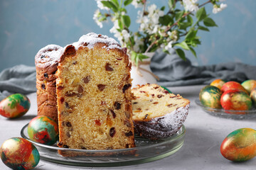 Easter cake Craffin and marble colorful eggs on a light blue background. Concept of the spring orthodox church holiday.