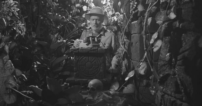 Explorer having a phone call in the jungle