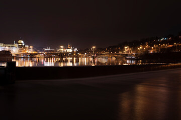 Fototapeta premium .panoramic view of Prague Castle and St. Vitus Cathedral and the Vltava River and street lights on bridges at night in the center of Prague