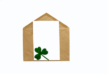 Brown open envelope with a white leaf with clover isolated on a white background, layout.