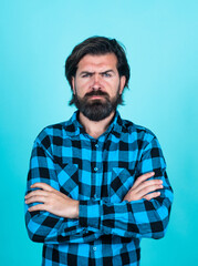 Fototapeta premium serious caucasian hipster with brunette hair having perfect beard and moustache crossed hands, barber