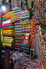 Arab store selling a variety of fabrics, Fabric in rolls