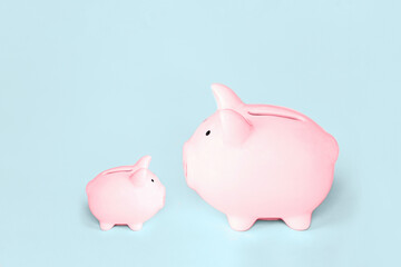 Pink piggy bank on blue background. Finance, saving money