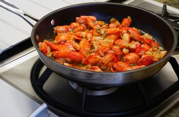 Sauteeing lobster meat in a pan