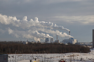 View n of the smoking chimneys of a thermal power plant on a sunny winter day. Southern Thermal...