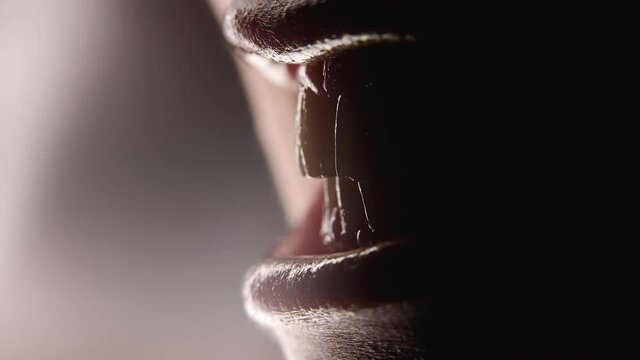 Close-up of female mouth, chattering teeth in anger like predator. Aggression, danger concept.