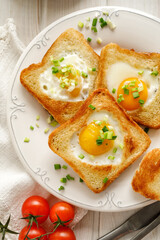 Valentine's Day toast with a fried egg in the shape of a heart for a festive breakfast, close up view. An idea for a romantic breakfast